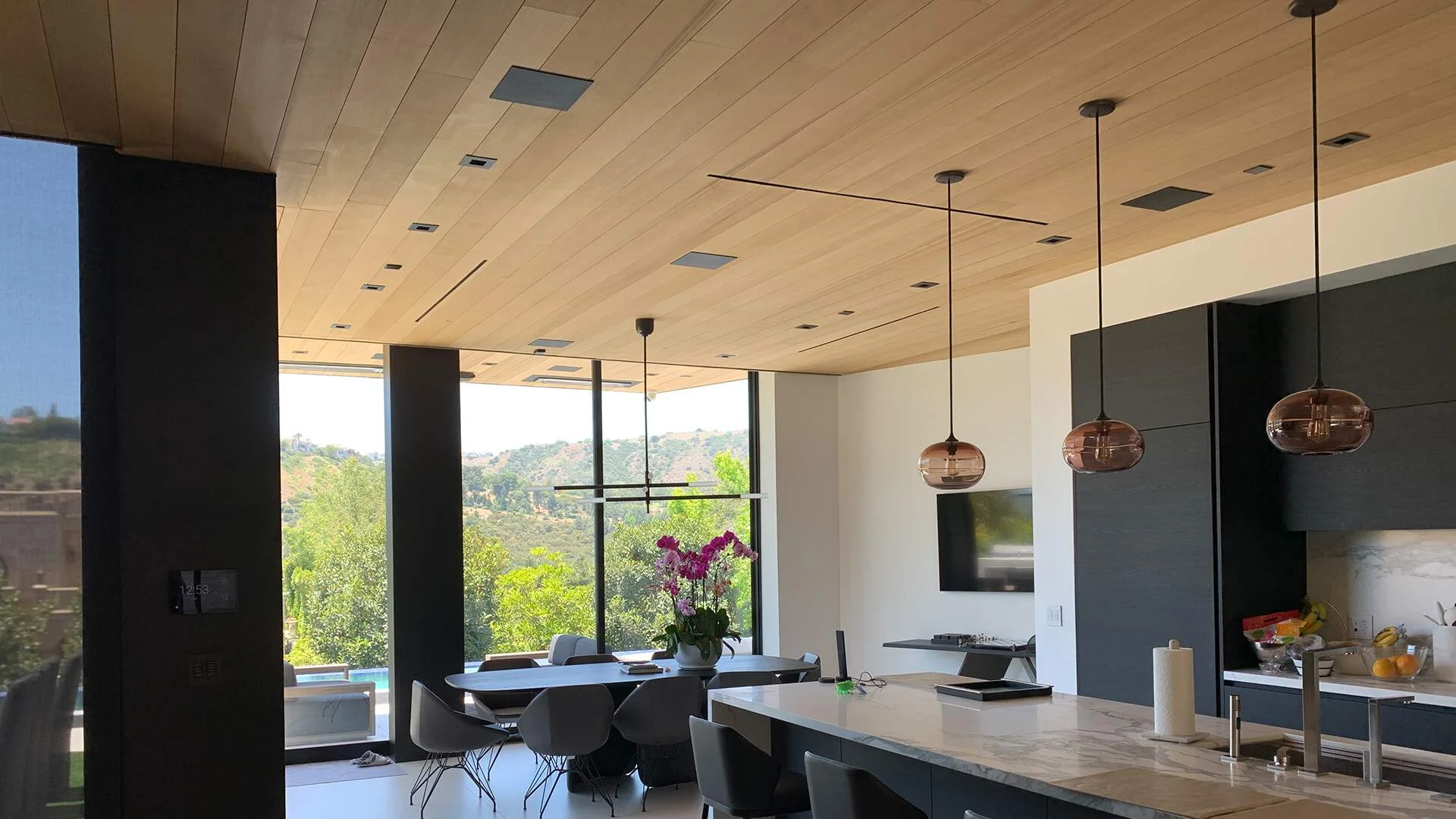 Open-plan kitchen and living remodel with natural light by R Builders