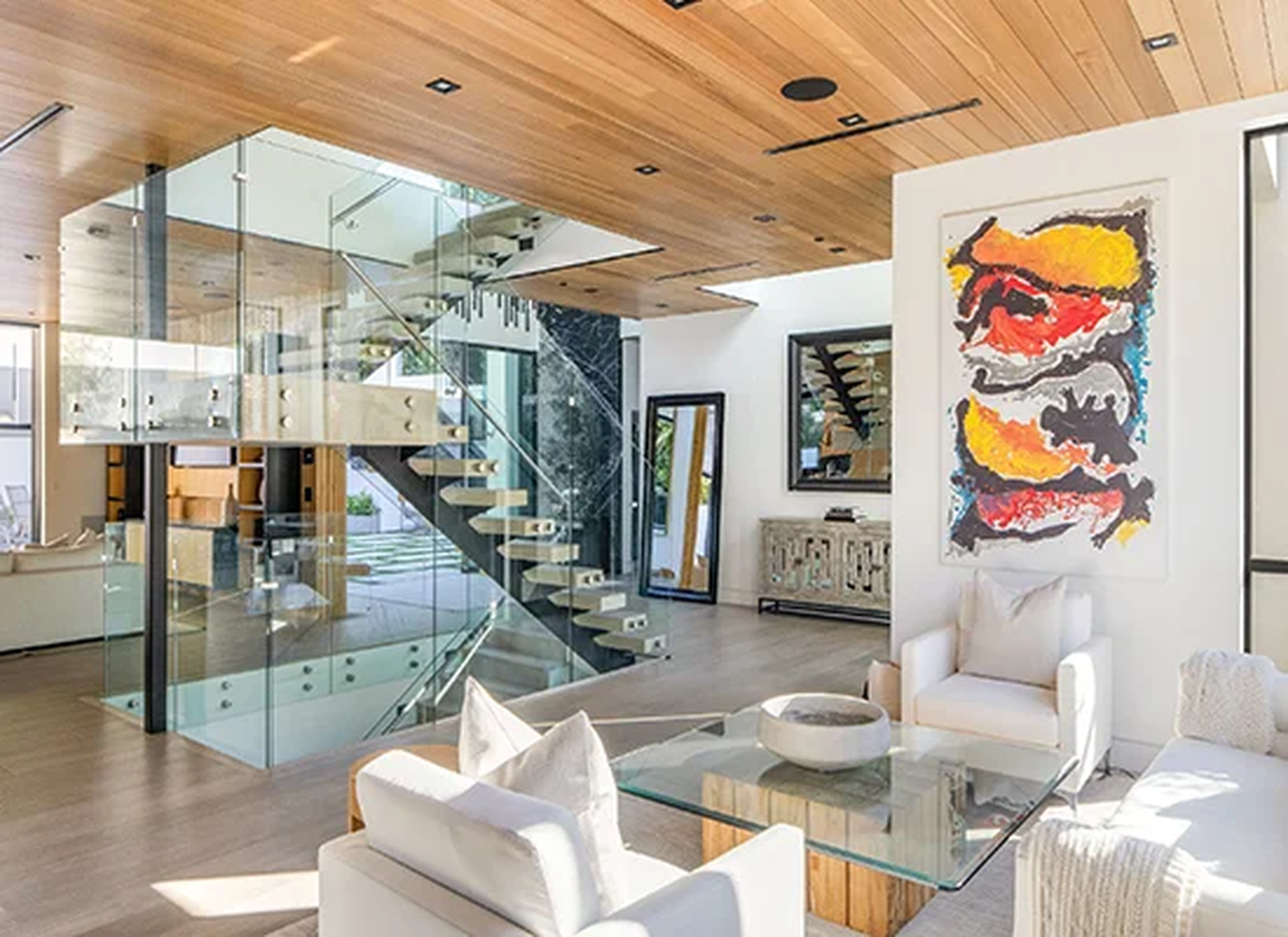 Luxury contemporary interior with custom staircase, wood ceiling and furnishings by R Builders
